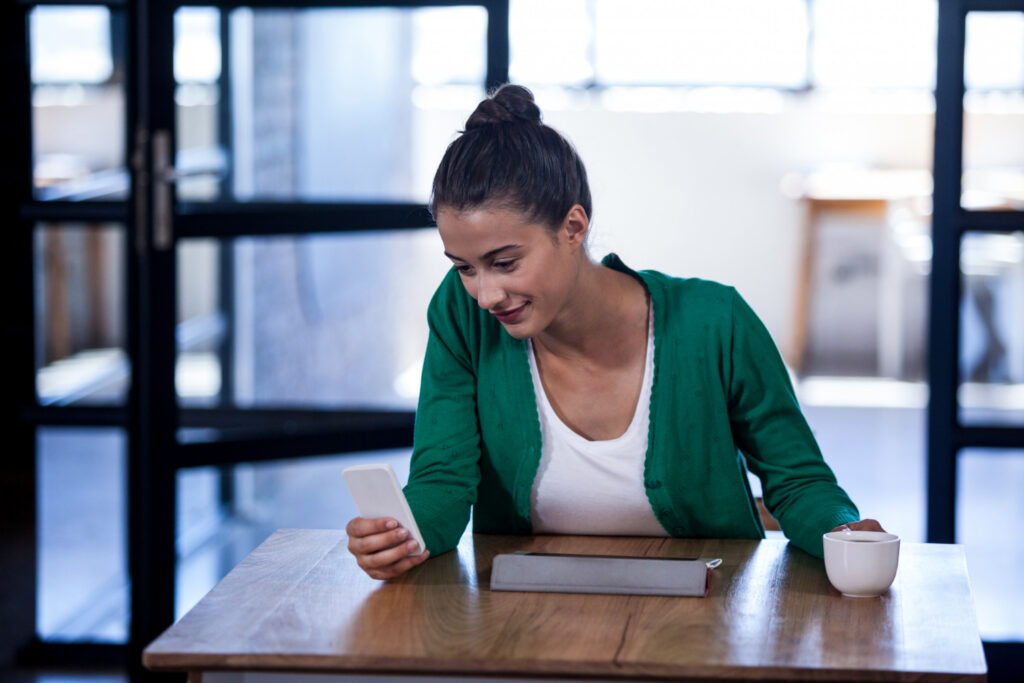 Pessoa comparando opções de crédito no celular para tomar uma decisão financeira consciente.